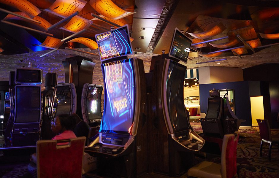 Photo of casino slot machines and two guests